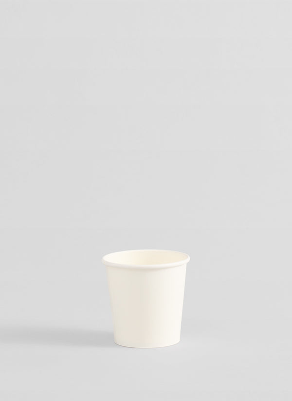 A single white paper cup centered on a light gray background.