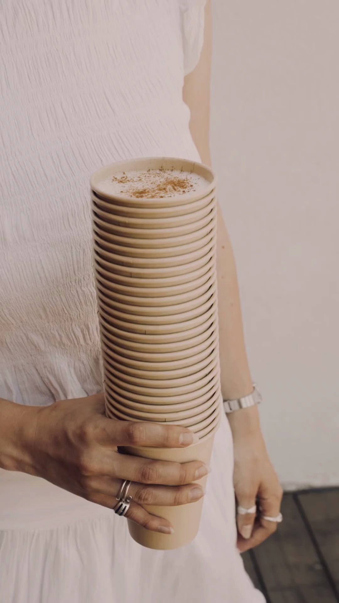 stack of bamboo cups with a cappuccino